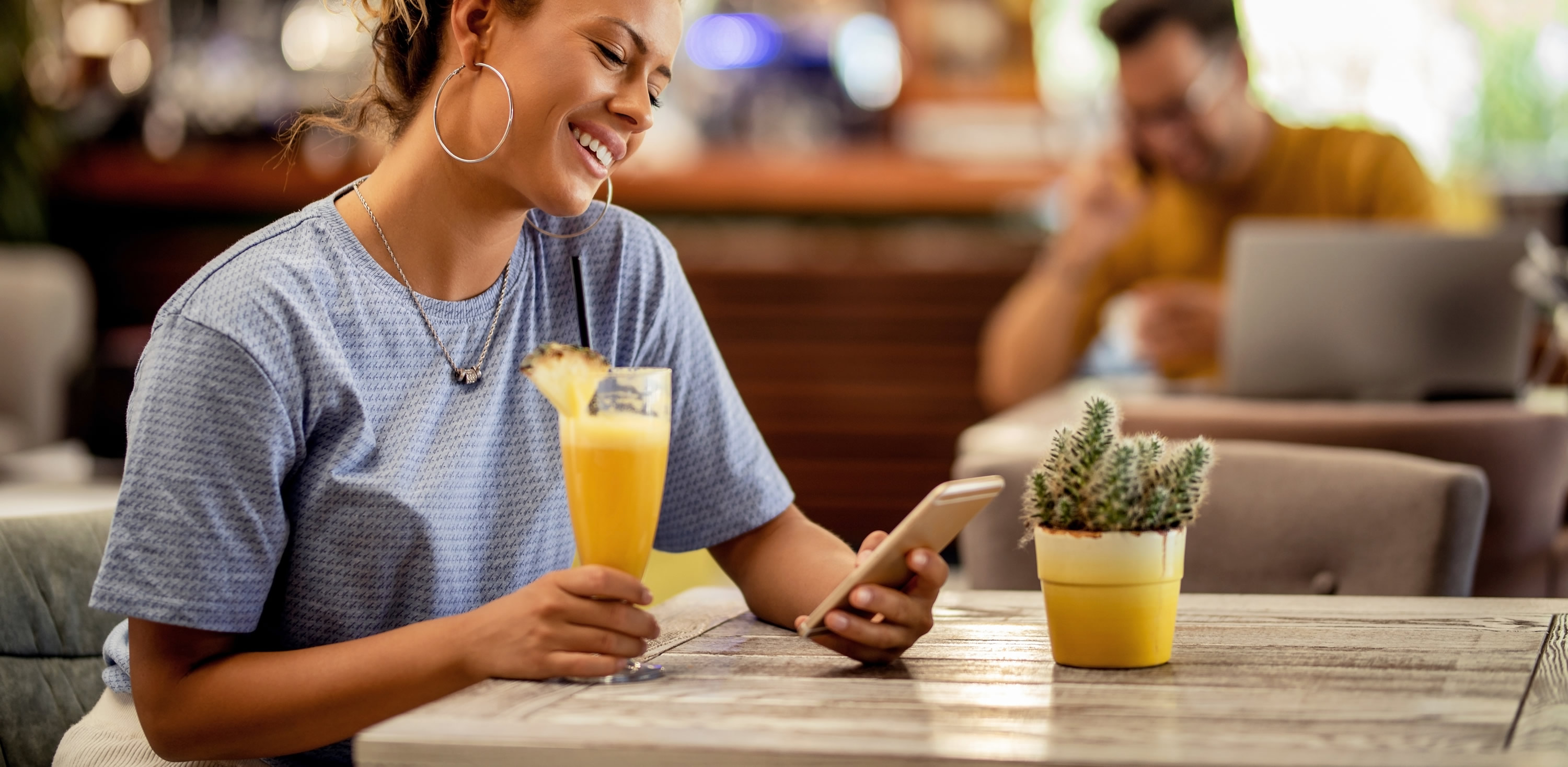 Guest relaxing at a hospitality venue while checking their phone