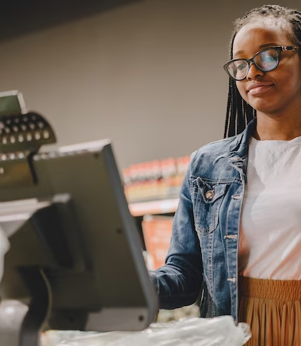 Cashier using a point-of-sale terminal on a retail counter